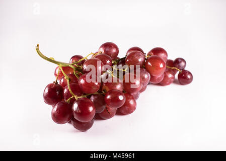 red grapes with stalks isolated on white background. fresh red grapes Stock Photo