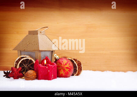 Christmas lantern and balls on a wooden background. Stock Photo