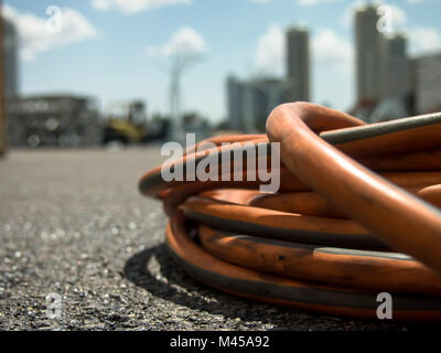 The Orange Extension Cord on the Ground at the Constructionsite Stock Photo