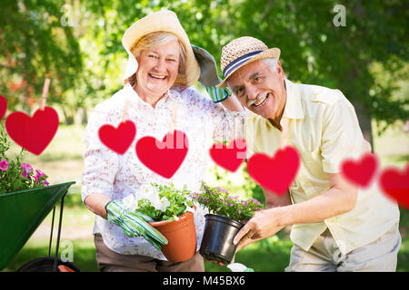Composite image of happy senior couple gardening Stock Photo