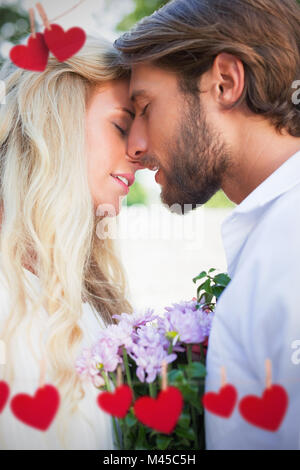 Composite image of attractive couple about to kiss each other Stock Photo