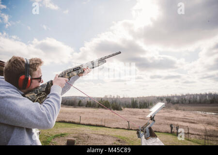 Man skeet shooting Stock Photo