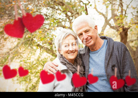 Composite image of senior couple in the park Stock Photo