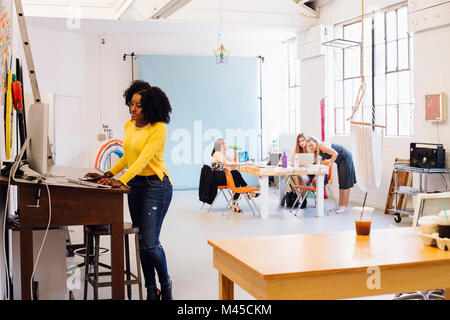 Woman using computer in creative studio Stock Photo