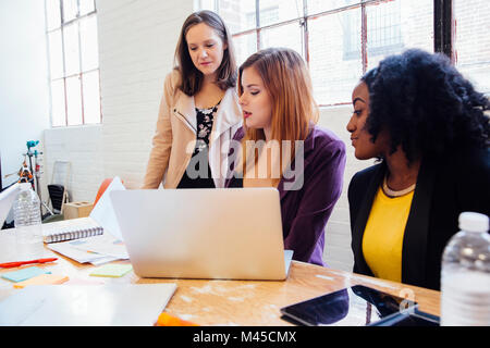 Colleagues in office discussing paperwork Stock Photo