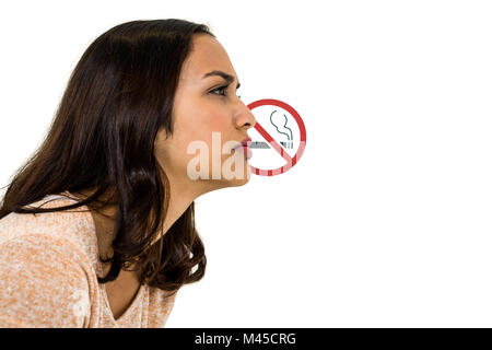 Serious woman looking away with no smoking sign Stock Photo