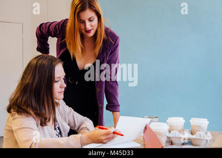 Colleagues in office discussing paperwork Stock Photo