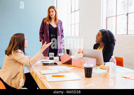Colleagues in office having discussion Stock Photo