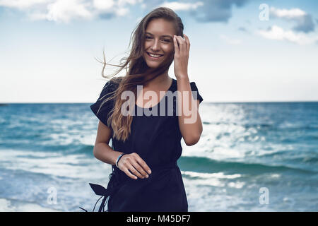 Portrait of happy young woman on beach, Odessa, Odessa Oblast, Ukraine Stock Photo