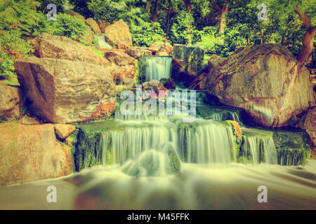 Waterfall in Japanese garden. Holland Park in London, UK. Stock Photo