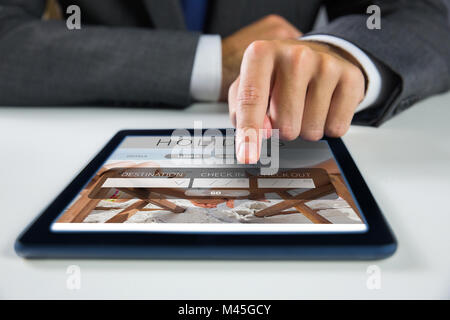 Composite image of businessman using digital tablet Stock Photo