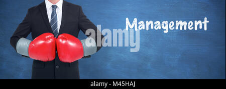 Composite image of businessman with boxing gloves Stock Photo