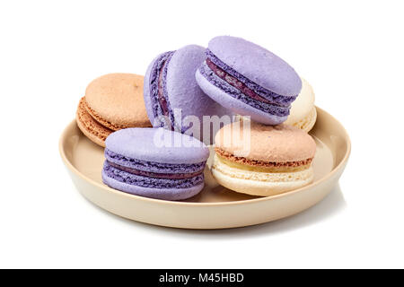 Plate vith violet and beige macarons on white Stock Photo