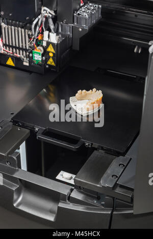 Open 3D Printer With Finished 3D Printed Dental Implant Bridge. Stock Photo