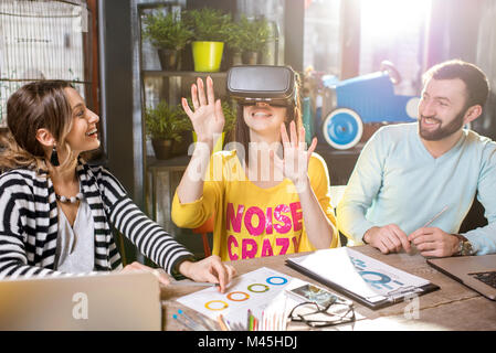 Friends using virtual reality glasses in the cafe Stock Photo