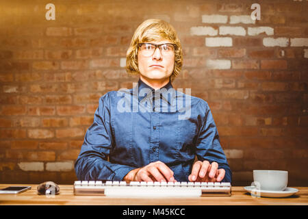 Composite image of focused hipster businessman using computer Stock Photo