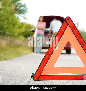 Adult man and women near broken car Stock Photo