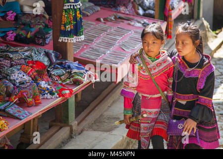 Local Hmong girls dressed in traditional clothing in Cat Cat Village in the valley of Sapa Vietnam Stock Photo