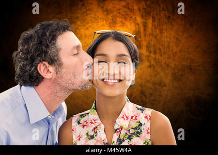 Composite image of man kissing woman on the cheek Stock Photo