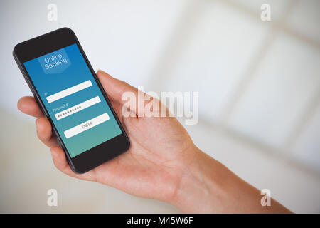 Composite image of womans hand holding black smartphone Stock Photo