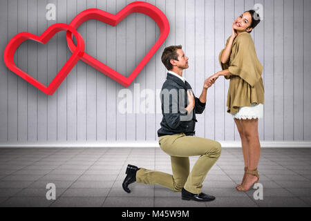 Composite image of man proposing woman while kneeling Stock Photo