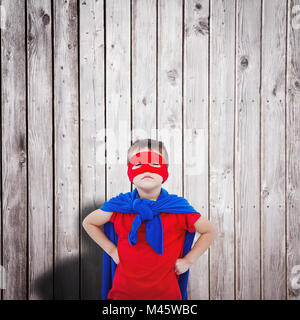 Composite image of masked boy pretending to be superhero Stock Photo