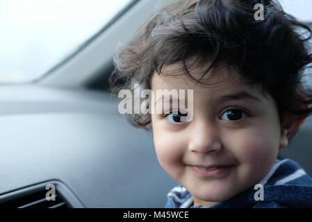 Close-up headshot of little girl Smiling and looking at camera Stock Photo