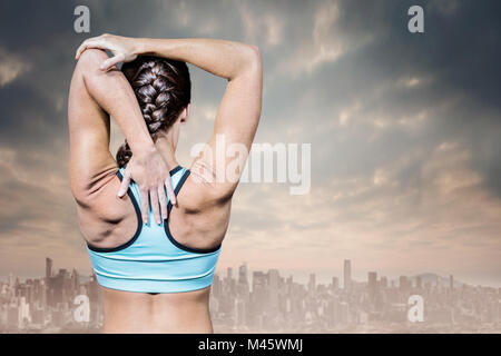 Composite image of rear view of woman stretching hands Stock Photo