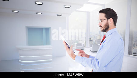 Composite image of businessman scrolling on his digital tablet Stock Photo