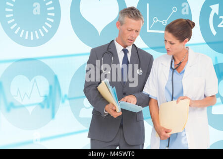 Composite image of male and female doctors discussing over reports Stock Photo