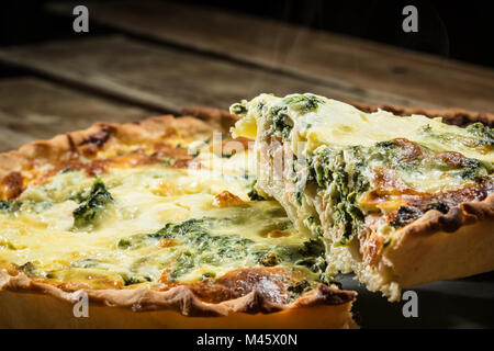 Traditional French cake. quiche with chard in white. Dark wood background. free space text Stock Photo