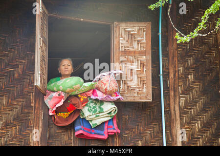 woman cleaning house in small town outside Bagan Myanmar Stock Photo