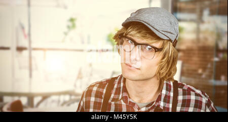 Composite image of serious blond hipster staring Stock Photo