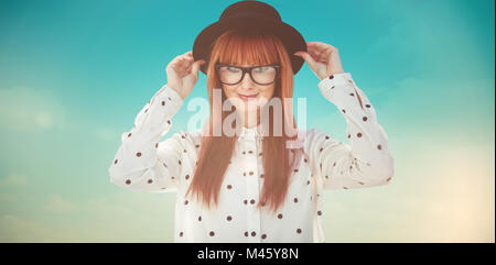 Composite image of attractive smiling hipster woman with hat Stock Photo