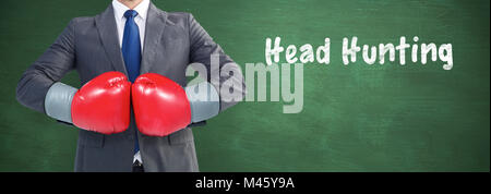 Composite image of businessman with boxing gloves Stock Photo