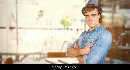 Composite image of serious hipster crossing his arms Stock Photo
