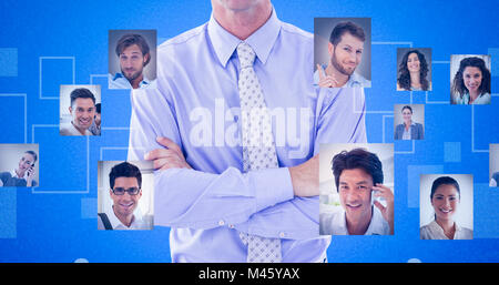 Composite image of portrait of smiling businessman standing arms crossed Stock Photo