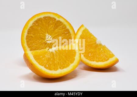 A freshly sliced Orange (Citrus x sinensis) on a white background Stock Photo