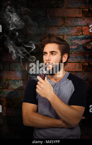 Composite image of confident hipster smoking pipe Stock Photo