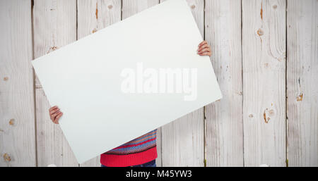 Composite image of hipster woman behind a big white card Stock Photo