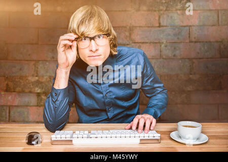 Composite image of focused hipster businessman using computer Stock Photo