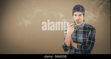 Composite image of portrait of confident hipster smoking pipe Stock Photo