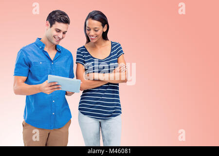 Composite image of smiling persons using tablet Stock Photo