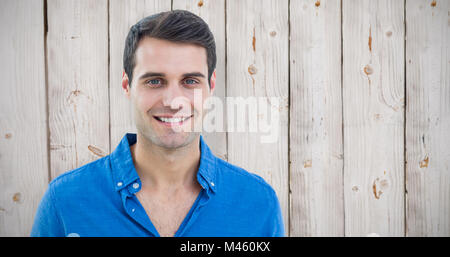Composite image of handsome man smiling to the camera Stock Photo
