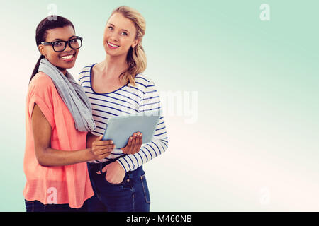 Composite image of businesswoman holding tablet Stock Photo