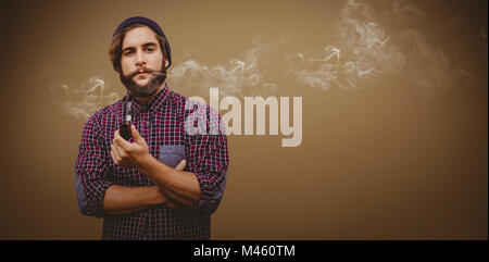 Composite image of portrait of confident hipster holding smoking pipe Stock Photo