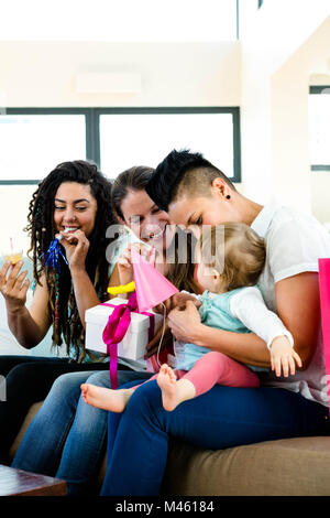 Three women celebrating a babies first birthday Stock Photo