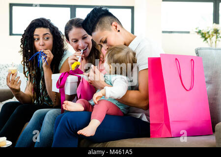 Three women celebrating a babies first birthday Stock Photo