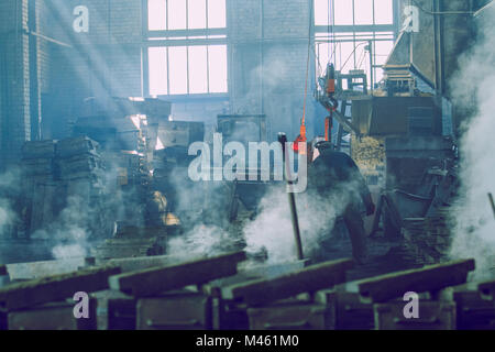 Cesis, Latvia, Metal foundry, workers pour metal, factory in city Cesis 2011. Stock Photo