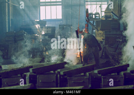 Cesis, Latvia, Metal foundry, workers pour metal, factory in city Cesis 2011. Stock Photo